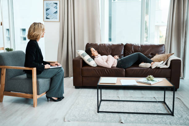 Shot of a young woman having a therapeutic session with a psychologist